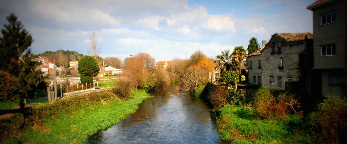 A river flowing through a town with buildings on both sides.