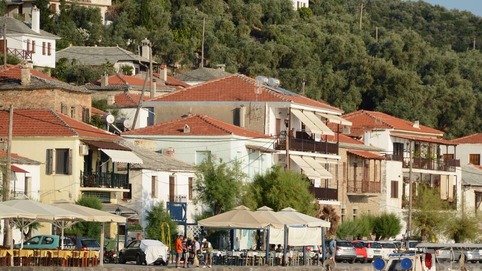 Neat houses, sea and boats on the pier - landscape Kala Nera, Greece