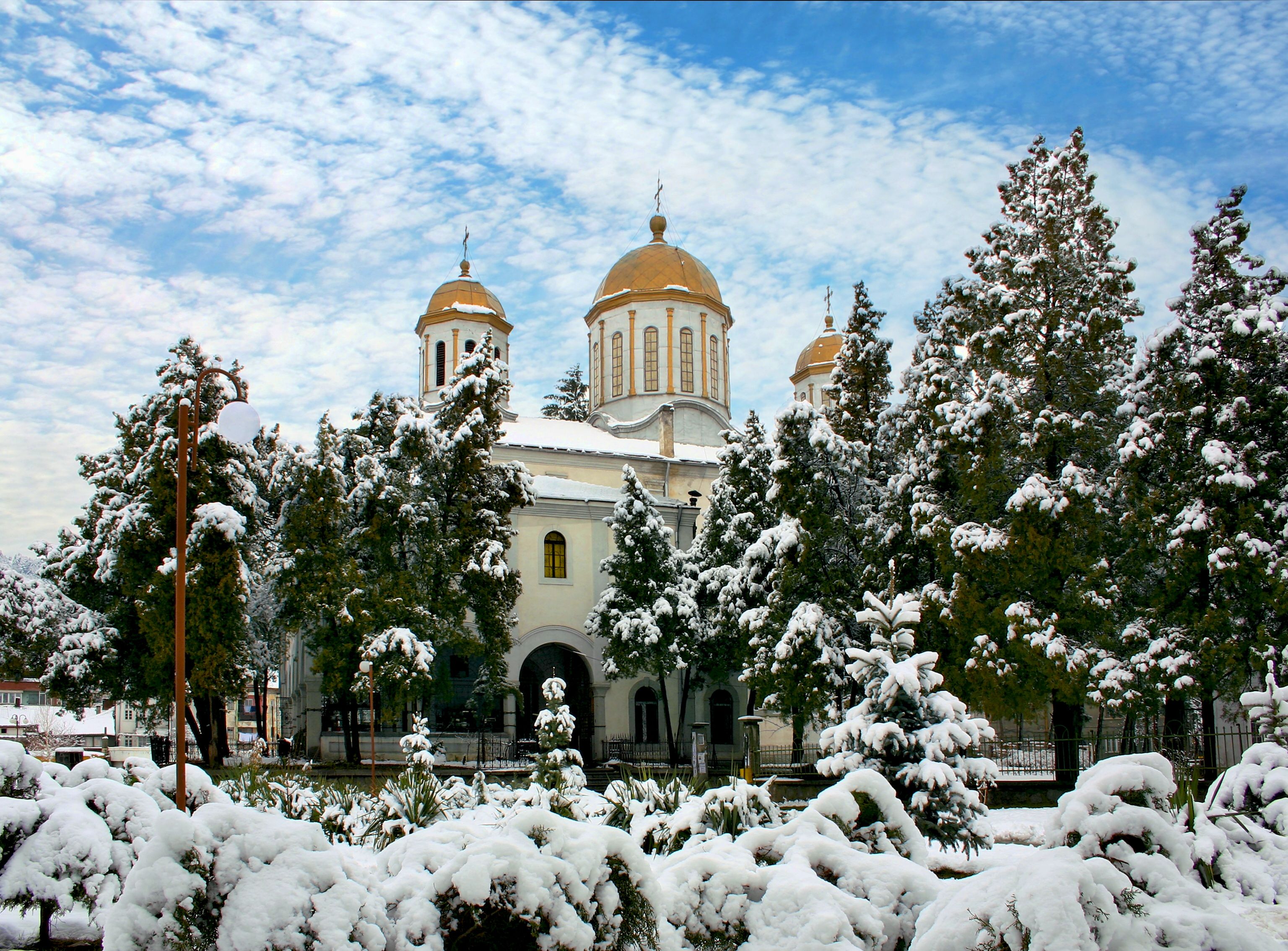 Una iglesia nevada con arquitectura abovedada y un cielo despejado.