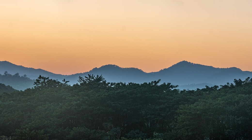 Sunset over the mountains with river and palm tree
