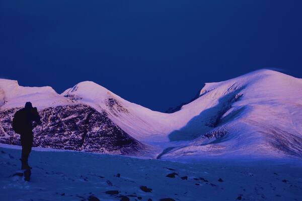 A photo taken a couple of years ago in the outskirts of Rondane National Park. We went there on foot in november and there was just little enough snow to still walk on foot. Got to experience this amazing light, with the sun settling in the west (behind us), and lighting up the central mountains in the area.