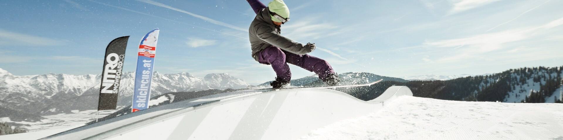 Saalbach-Hinterglemm Ski Resort showing snow boarding and snow as well as an individual male