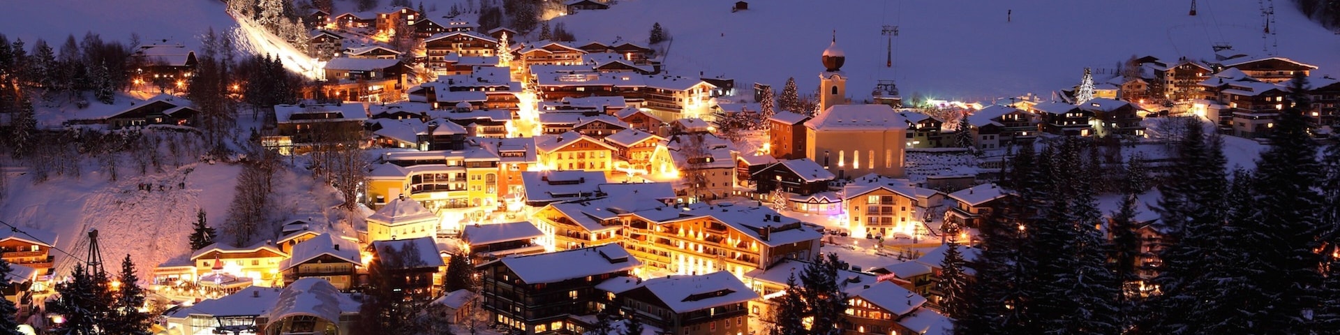 Saalbach-Hinterglemm Ski Resort which includes night scenes, a small town or village and snow