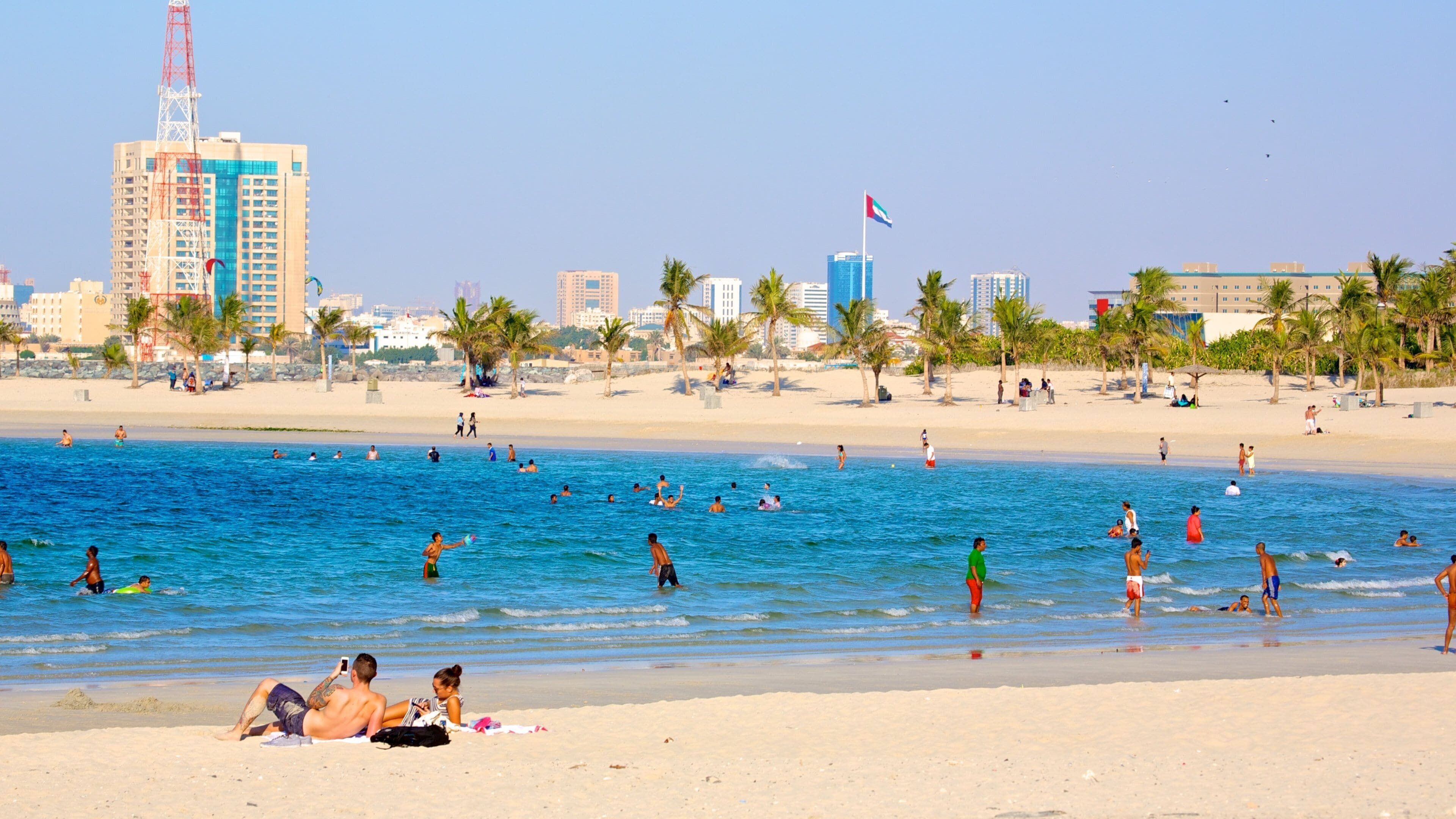 Al Mamzar Beach Park which includes swimming, a sandy beach and general coastal views