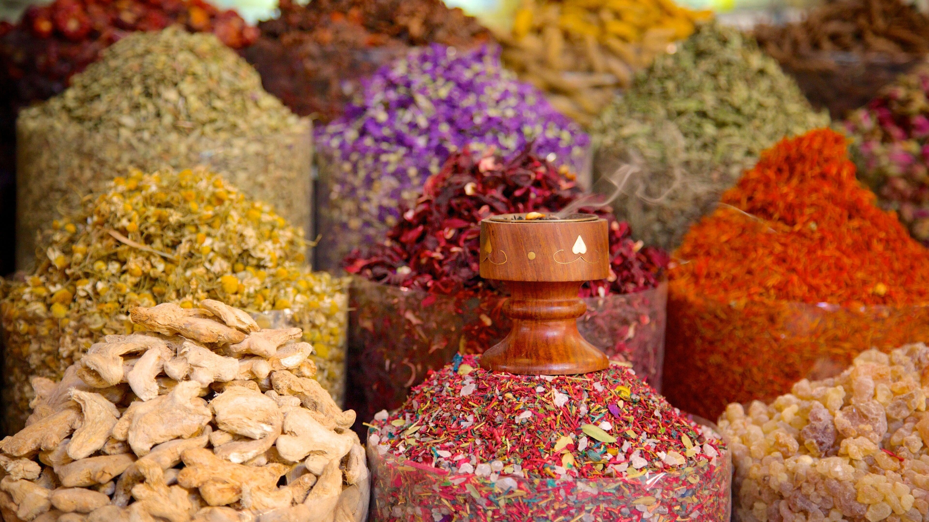 A variety of colorful spices and herbs displayed in containers.