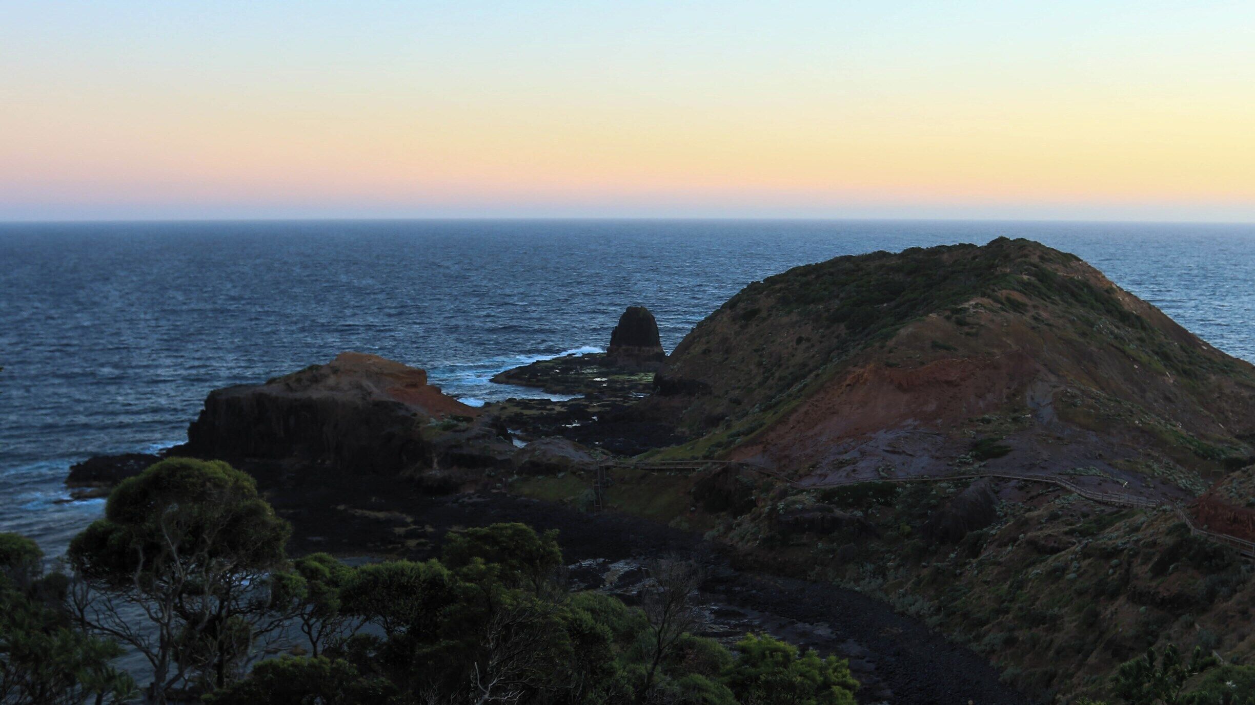 Sunset from Cape Schanck which overlooks Bass Strait at the southernmost tip of the Mornington Peninsula. It is a rocky point with limestone cliffs and a historic lighthouse built in 1859 that still operates today. It's quite special in some way in that the scenic boardwalk allows you to access the rocky beaches on the Cape along with the rock platforms around Pulpit Rock at the tip of the Cape.

