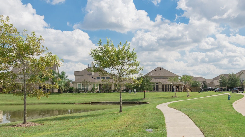 Walking pathway alongside leads to residential houses by the lake in Pearland, Texas, USA. Panorama style.