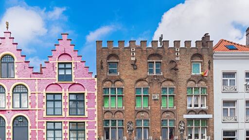 Traditional colorful Belgian facades of houses at Market square in city of Bruges.