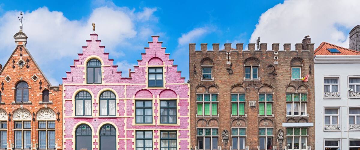A row of colorful historic buildings with distinct architectural styles.