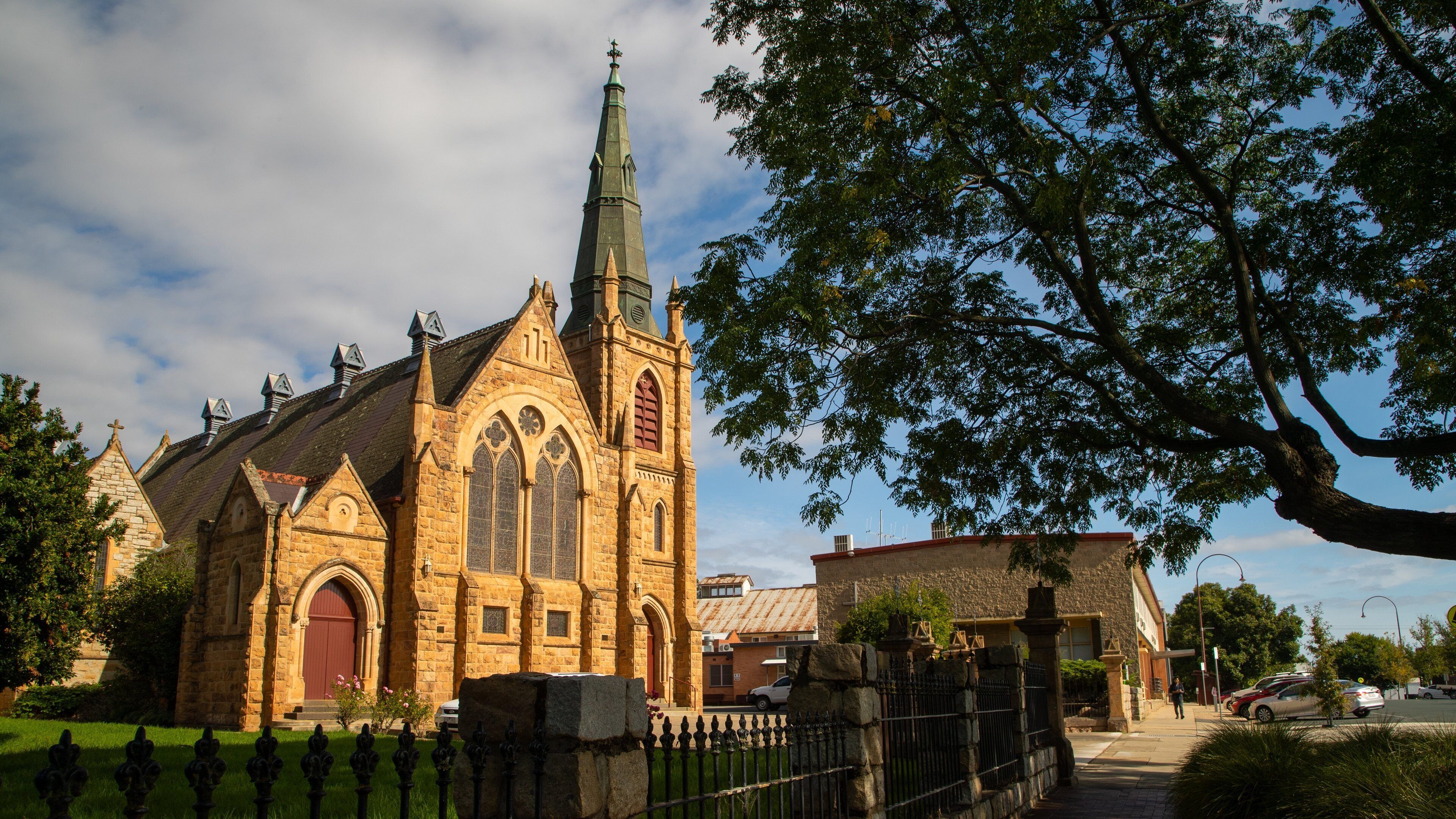 A historic church with a tall spire and arched windows.