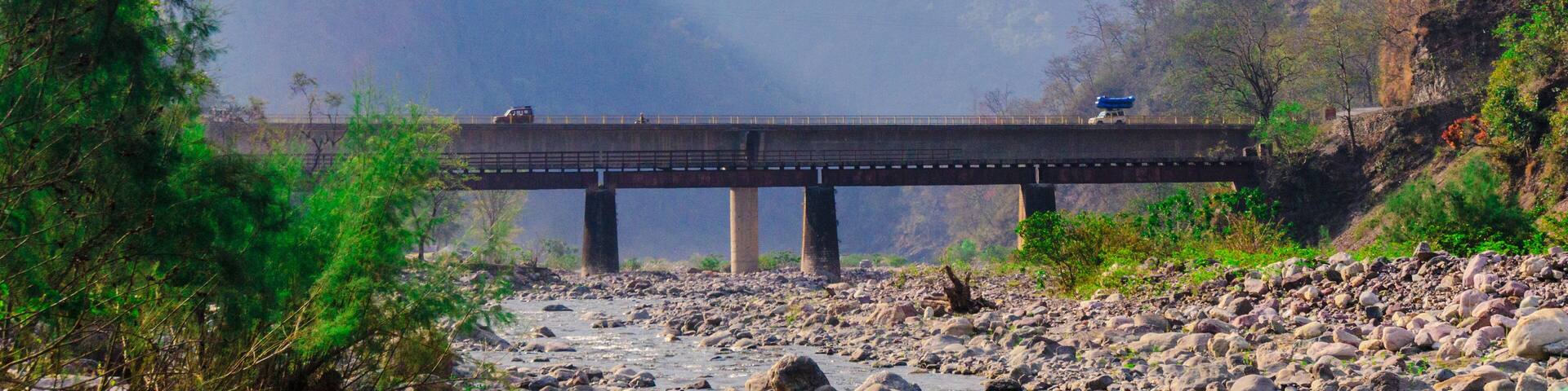 Shot in a valley in the himalayas the light coming off the mountain and hitting the bridge make this a perfect tourist picture for travel in India