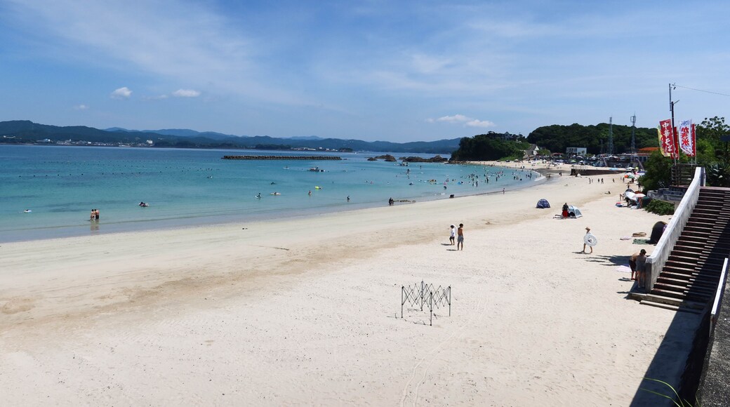 good weather greenish blue sea and beach withe people swimming in the sea and playing on the sad taken in Ise, Mia, Japan