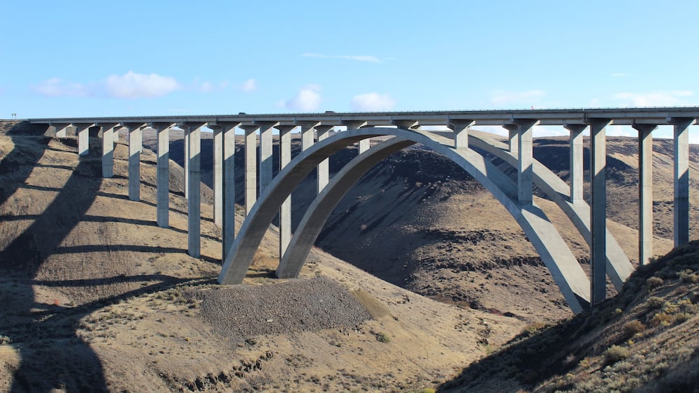 Fred G. Redmon bridge over the Selah creek outside Yakima , Washington. its a beautiful bridge between the canyon with a arch support below in concrete. Blue sky and and clouds in the sky .