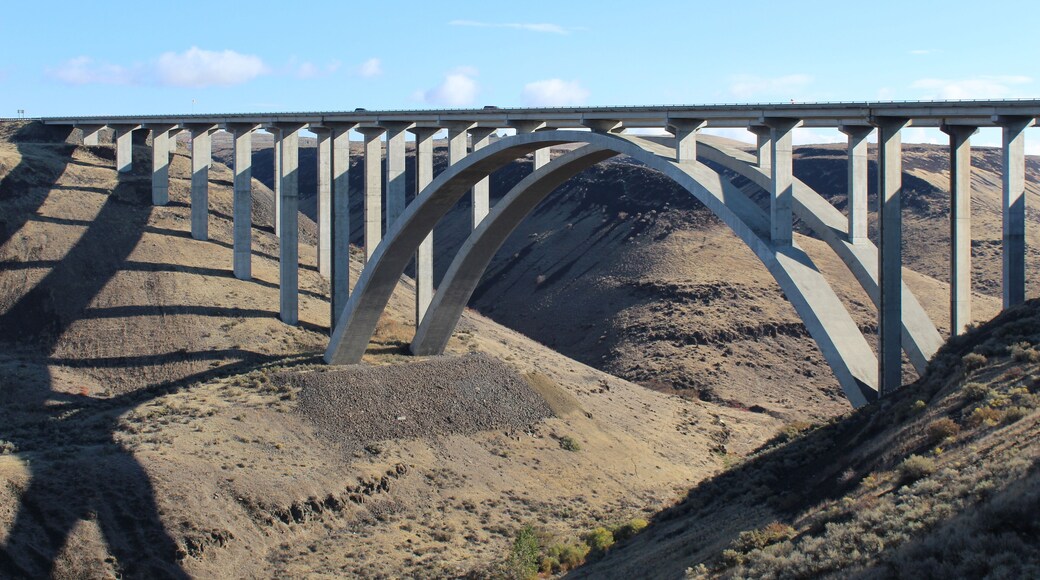 Fred G. Redmon bridge over the Selah creek outside Yakima , Washington. its a beautiful bridge between the canyon with a arch support below in concrete. Blue sky and and clouds in the sky .