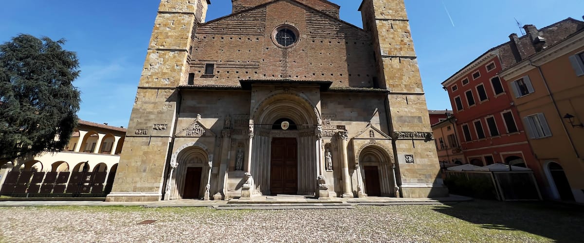 A historic church with two towers, a central dome, and a large arched entrance.