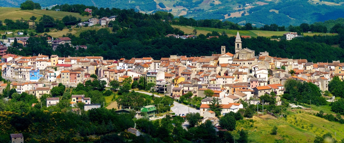 A town nestled in a valley surrounded by hills.