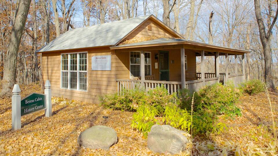 A wooden cabin named Berens Cabin, surrounded by trees and autumn leaves.