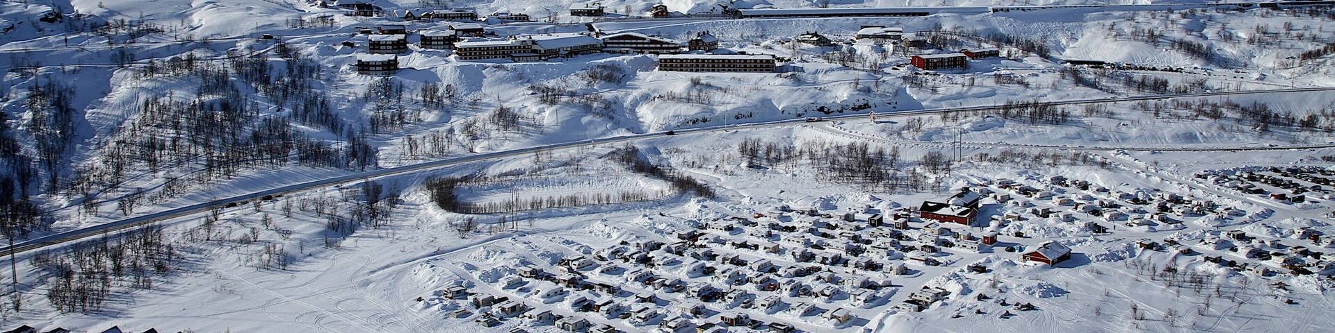 Riksgransen showing snow and a small town or village