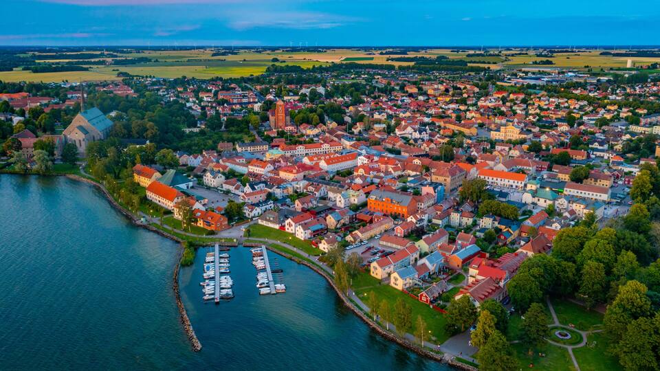A coastal town with a marina, historic buildings, and a river.