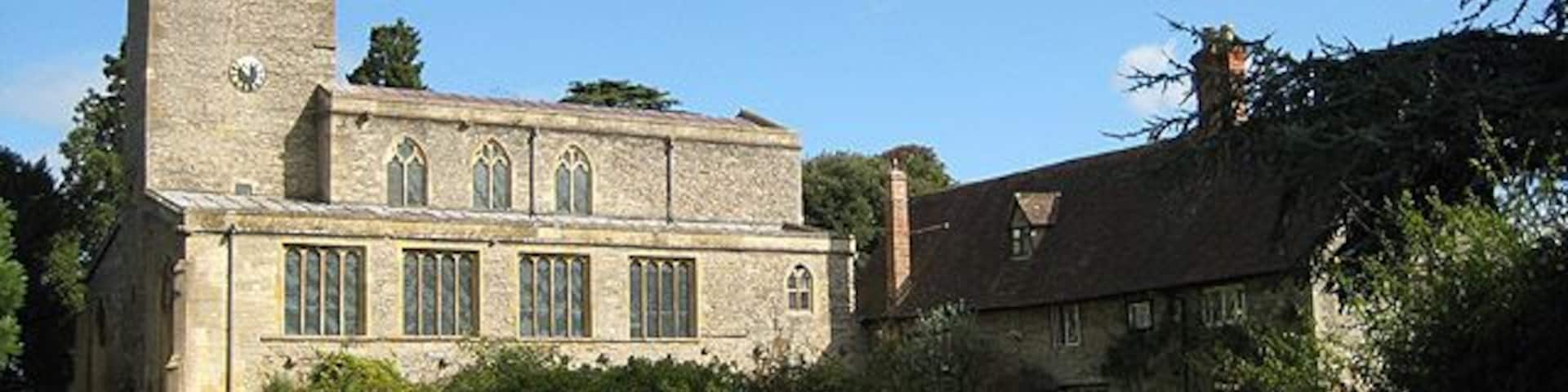 Priory church of St Mary, Deerhurst, Gloucestershire, seen from the southwest, with Priory Farmhouse on the right