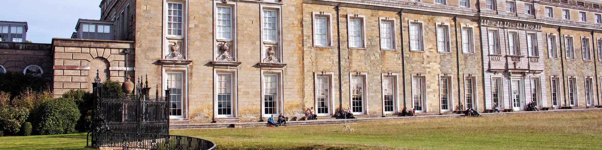 A historic building with large windows and a stone facade.