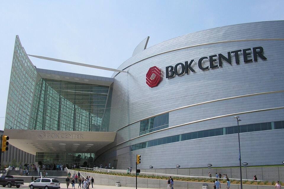 The Bok Center building with a modern glass facade and a prominent red logo.
