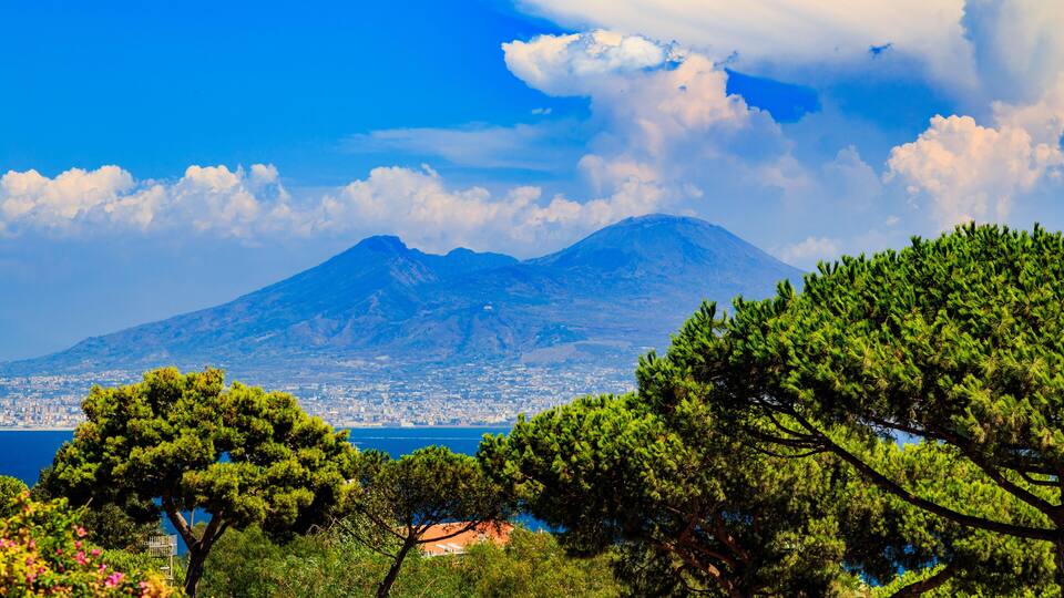 A mountain, trees, and a body of water.