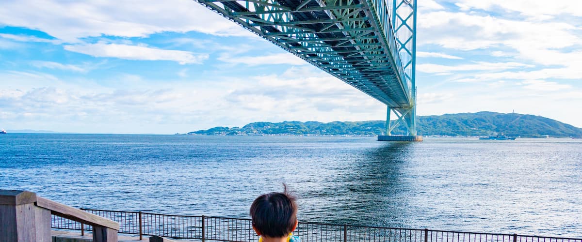 Akashi Kaikyo Bridge and a boy. Tarumi-ku, Kobe City, Hyogo Prefecture, Japan