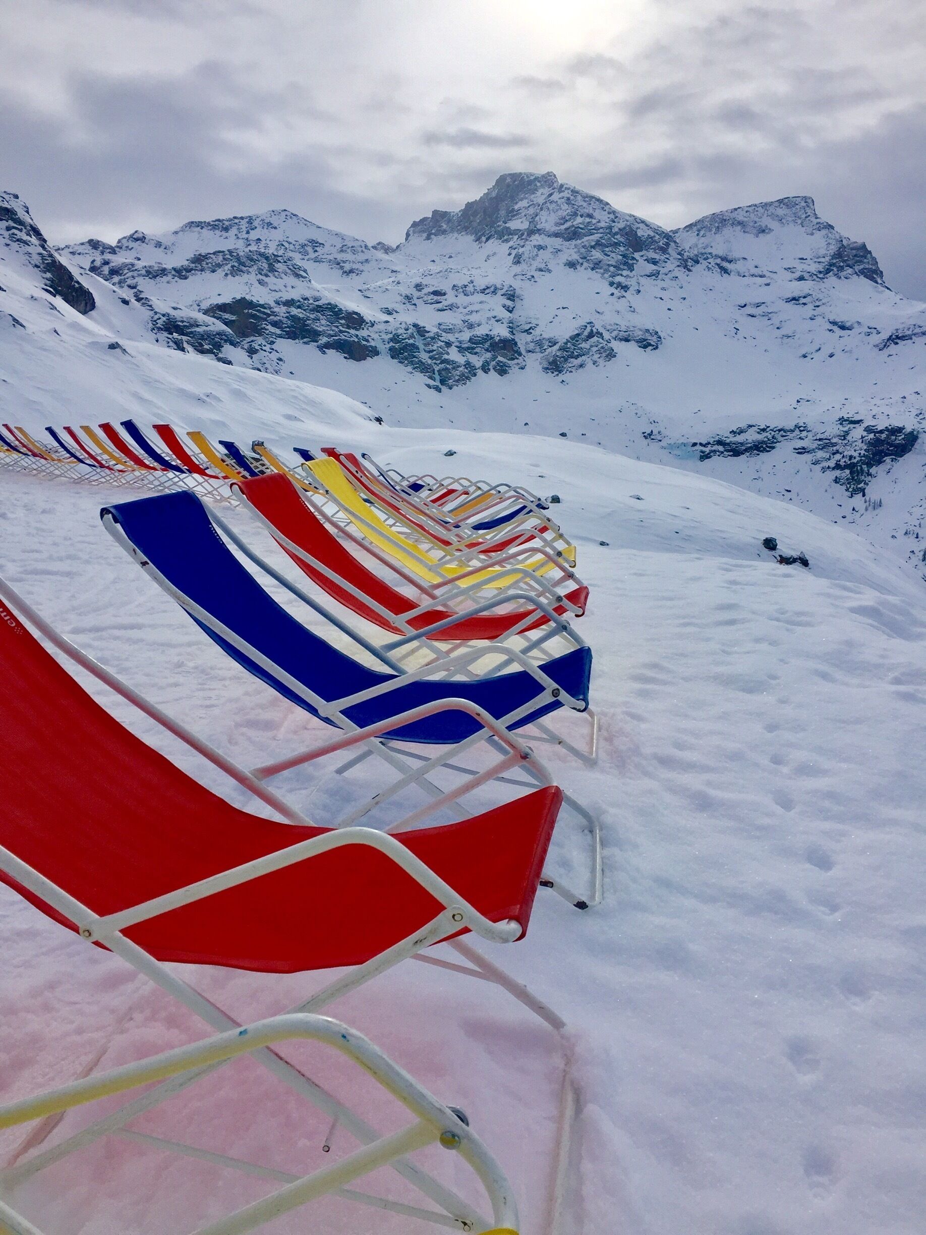 Waiting for the sunshine to appear to enjoy these colourful deckchairs.