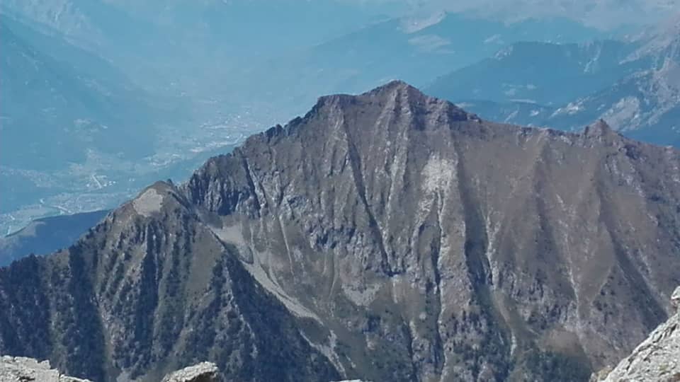 A rugged mountain peak with steep slopes and rocky terrain.