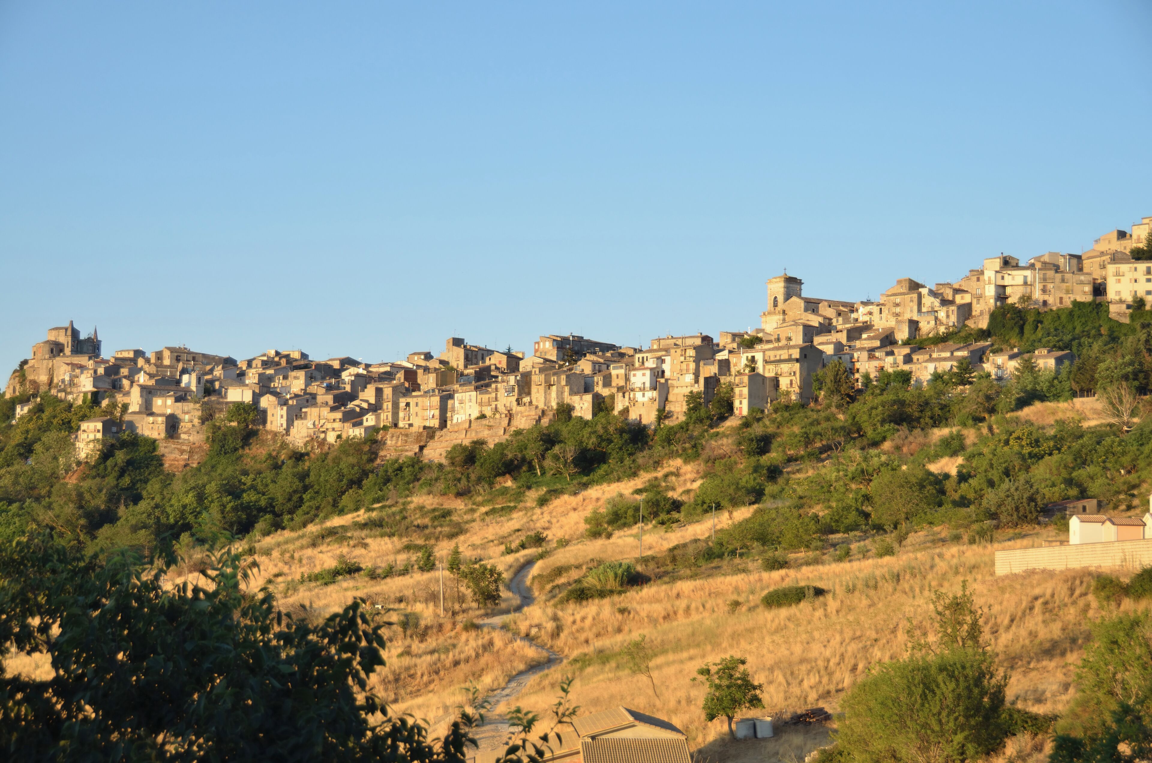 A hillside settlement with dense buildings and a prominent church.