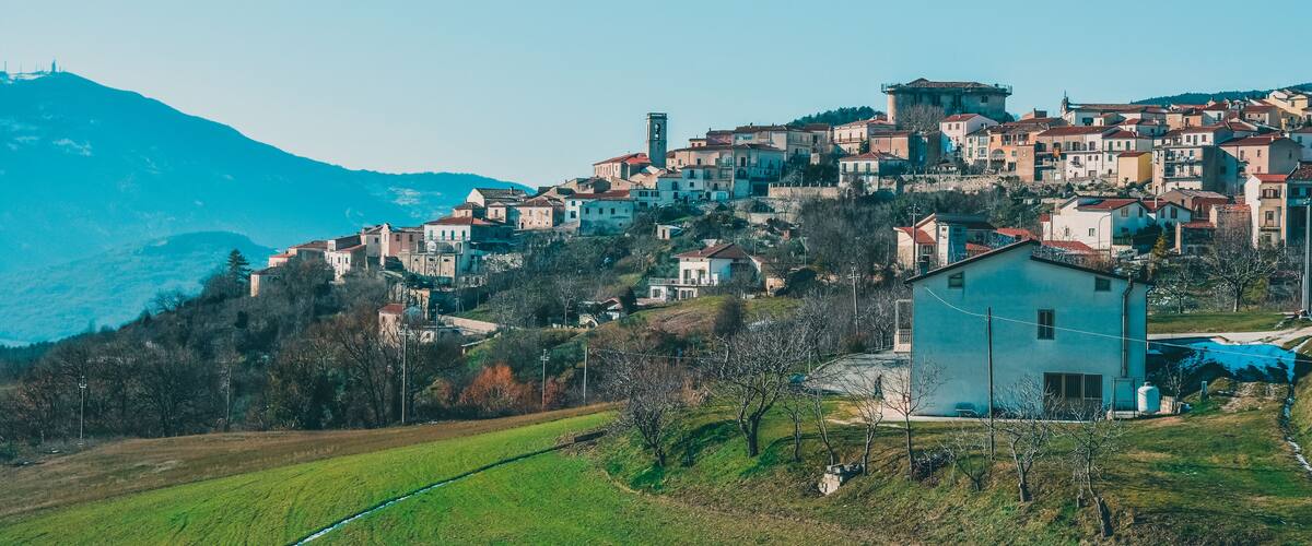 A hillside village with historic buildings and a prominent church.