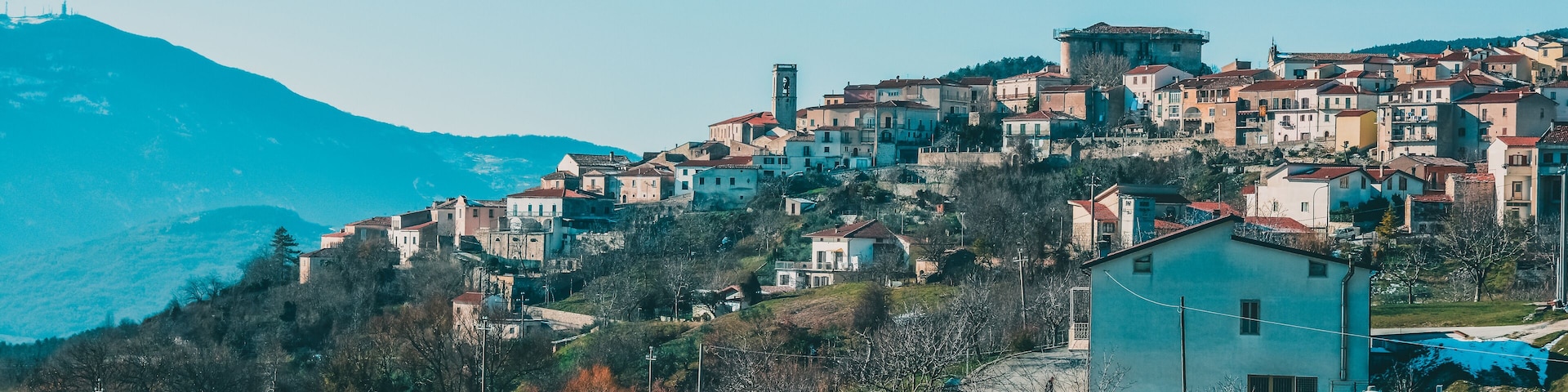 A hillside village with historic buildings and a prominent church.