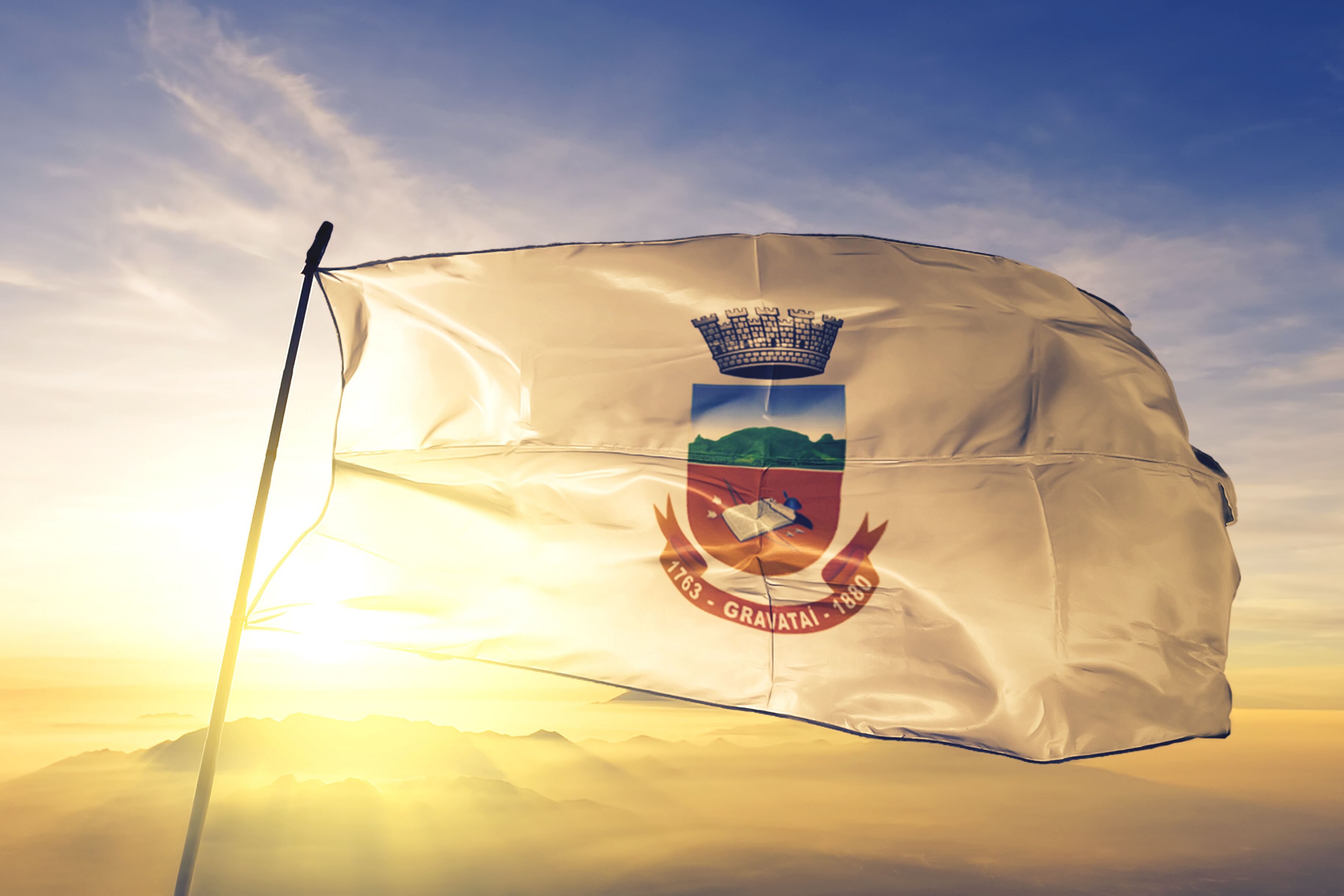 Gravatai of Brazil flag waving on the top sunrise mist fog