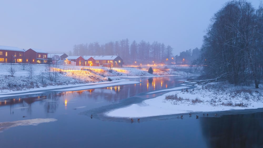 Scenic view of river against clear sky during winter