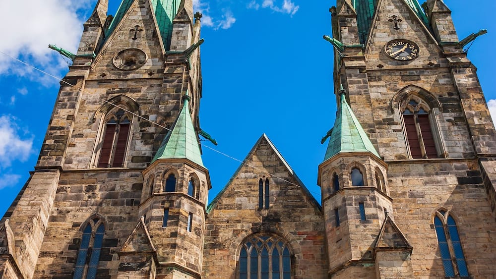 A historic church with twin spires and a large central window.