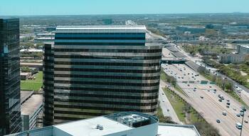 Panorama aerial view rooftop of modern glass office buildings, corporate office headquarters in Westchase business district, busy Sam Houston Tollway and Richmond Ave intersection, mixed use area