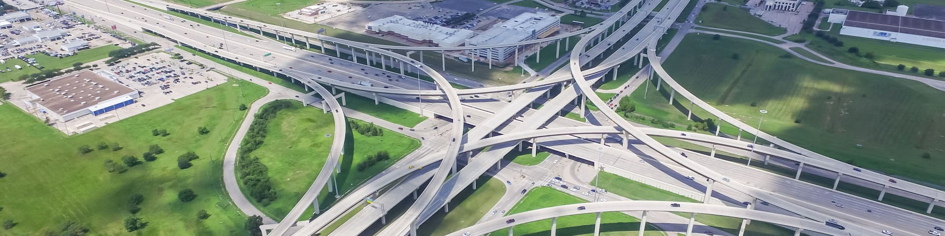 Panorama vertical aerial Interstate 10 or Katy freeway massive intersection, stack interchange, elevated road junction overpass cloud blue sky. Top view metropolitan area of Katy, Texas, USA
