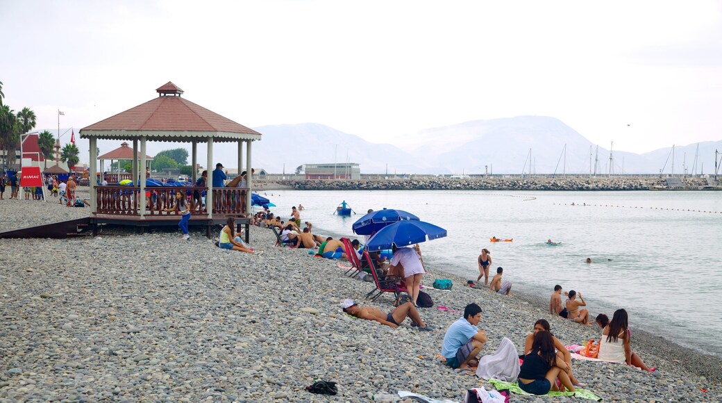 Punta Hermosa which includes a pebble beach and general coastal views as well as a large group of people