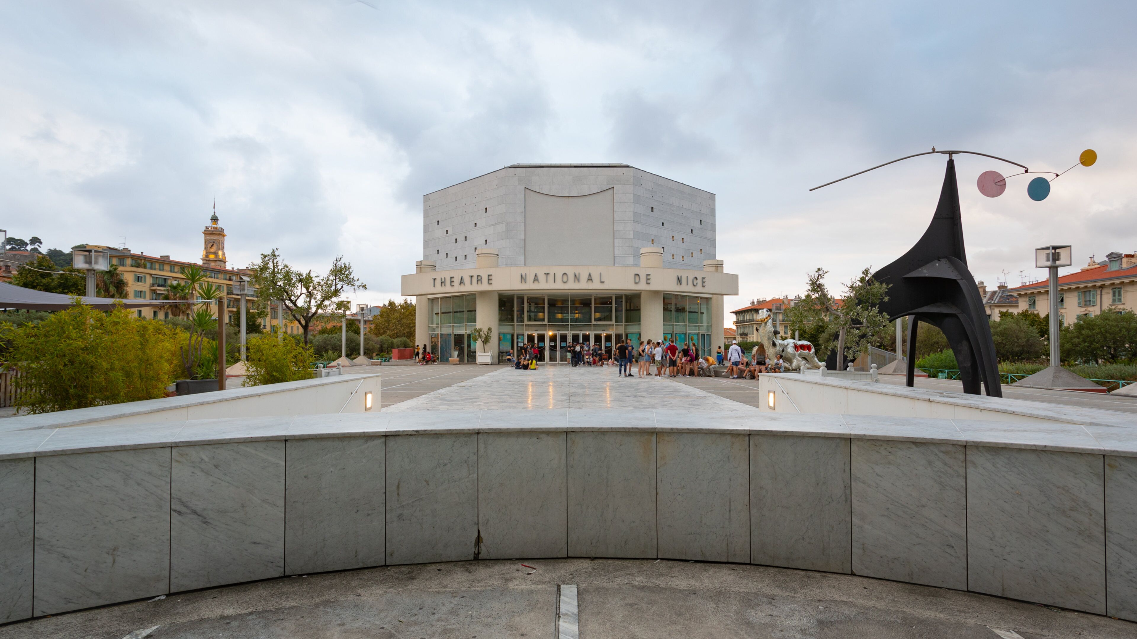 Nice Theatre which includes signage and a square or plaza as well as a small group of people