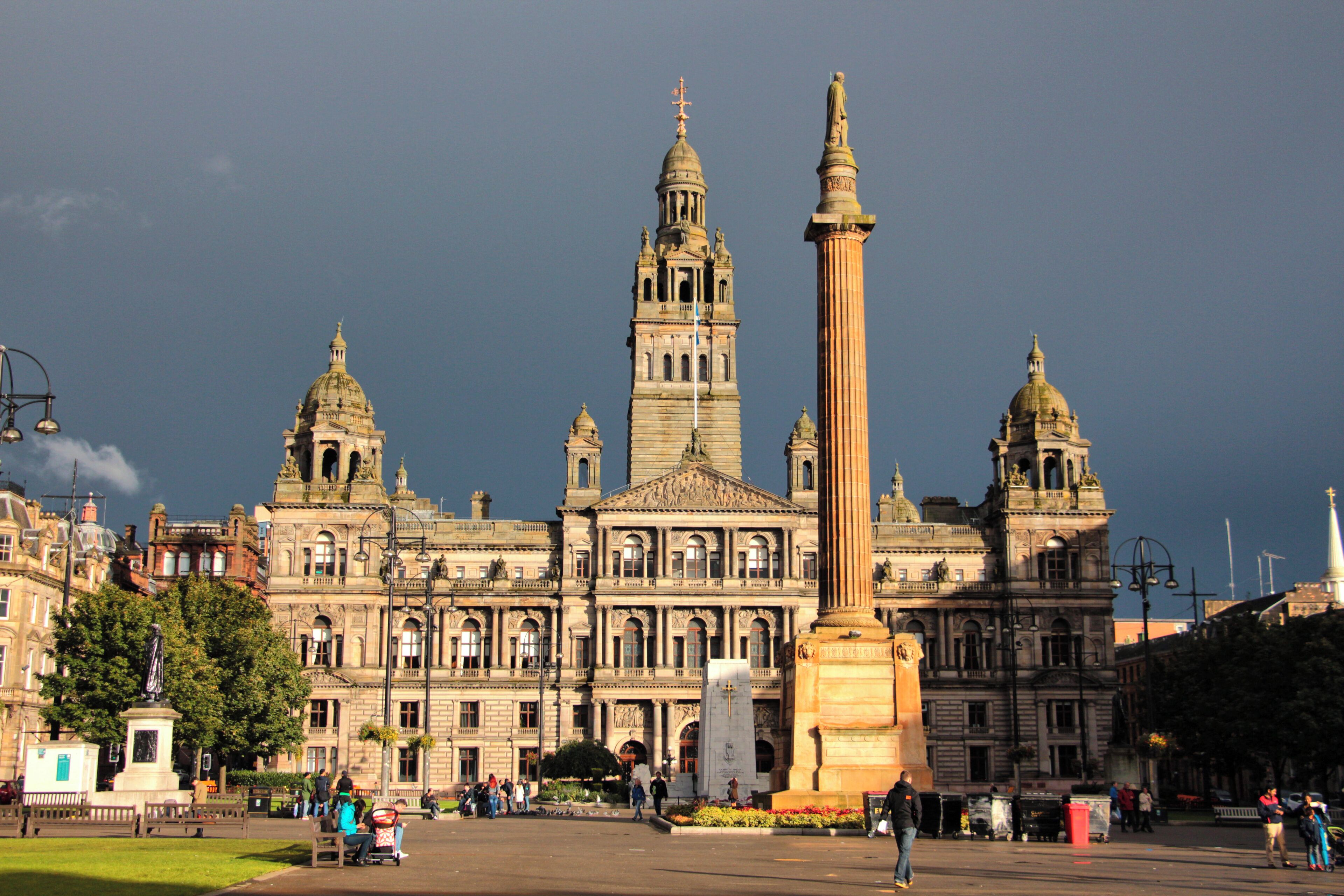 A historic building with domed towers and a tall obelisk.