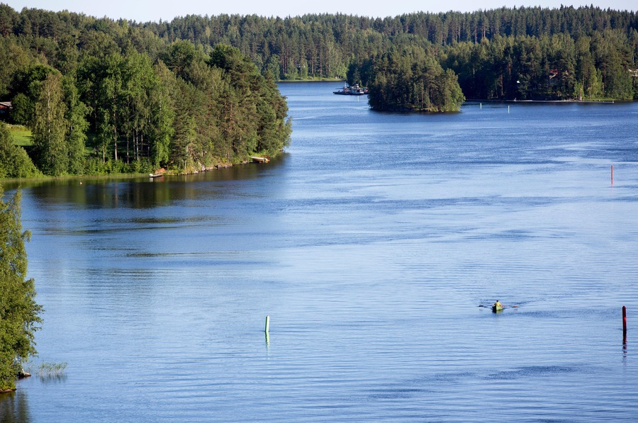 Man rowing a rowboat at Leppavirta river , Finland