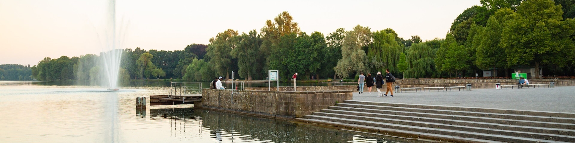 Maschsee which includes a sunset, a fountain and a river or creek