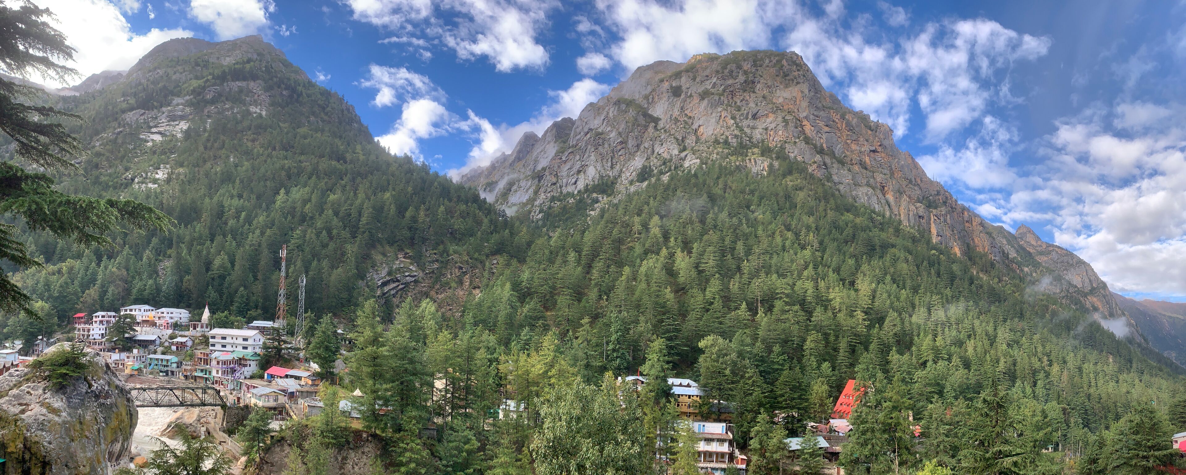 A mountainous landscape with a village nestled among the trees.
