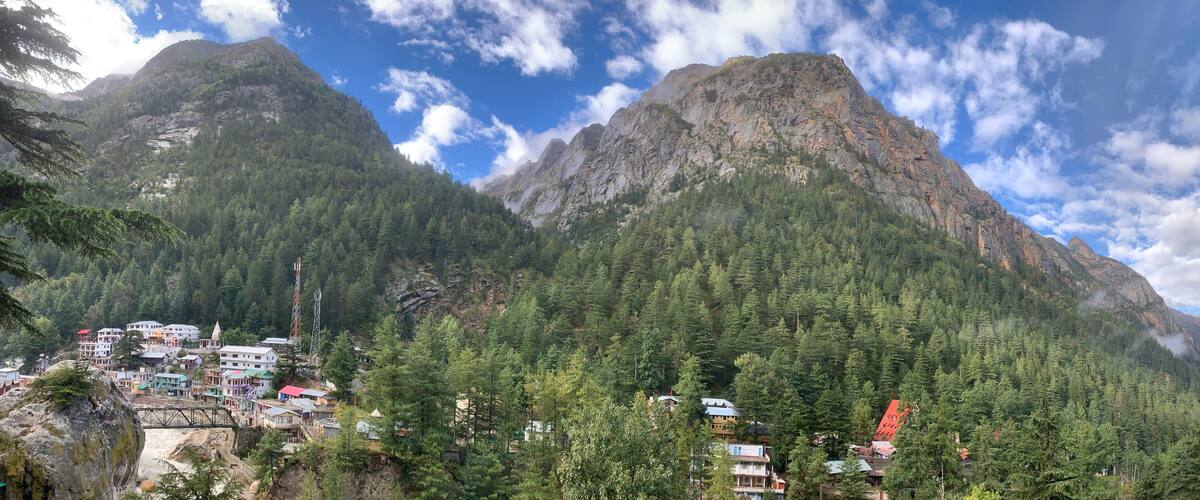 A mountainous landscape with a village nestled among the trees.