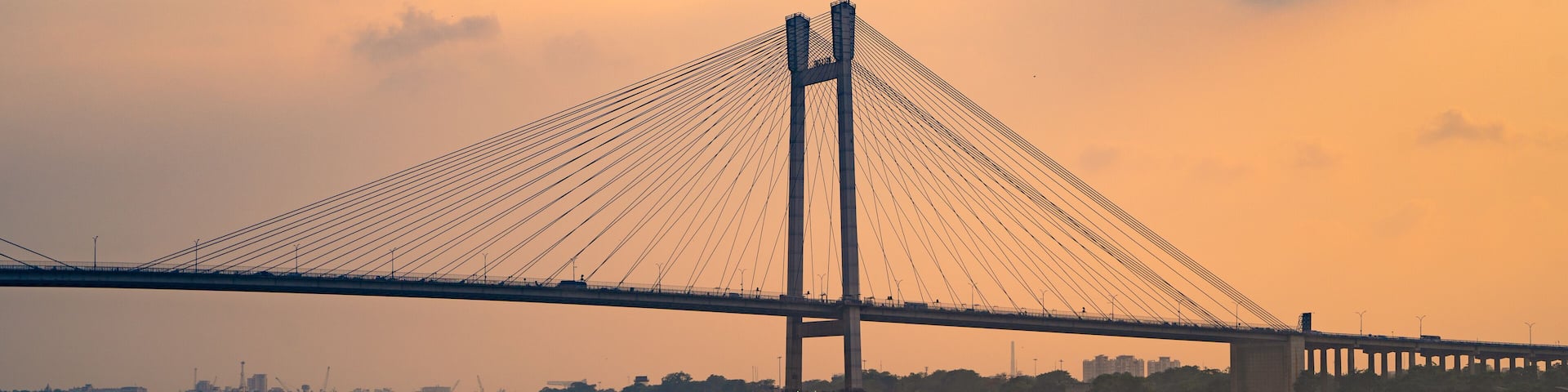 A river with a bridge in the background.
