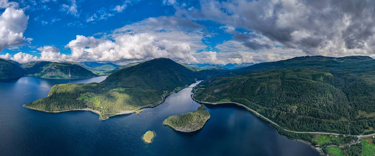 A lake surrounded by forested mountains and islands.