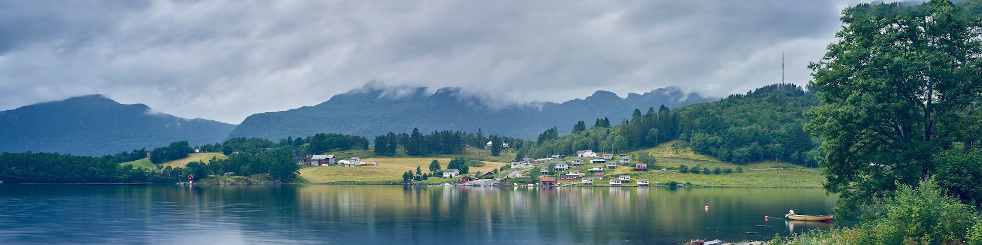 Panoramic view of fjord distant village, Etne, Norway