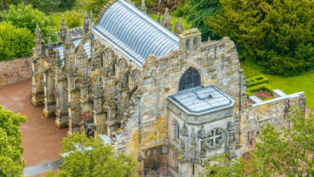 Aerial view of Rosslyn Chapel, it was founded in 1446 by Sir William St Clair. Rural Midlothian. Da Vinci Code movie. Ley lines and rose line. Edinburgh. Scotland. UK