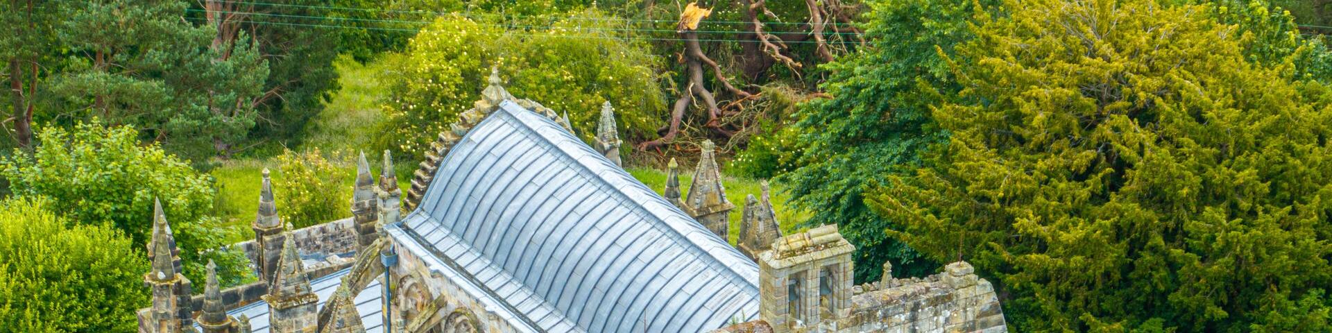 Aerial view of Rosslyn Chapel, it was founded in 1446 by Sir William St Clair. Rural Midlothian. Da Vinci Code movie. Ley lines and rose line. Edinburgh. Scotland. UK